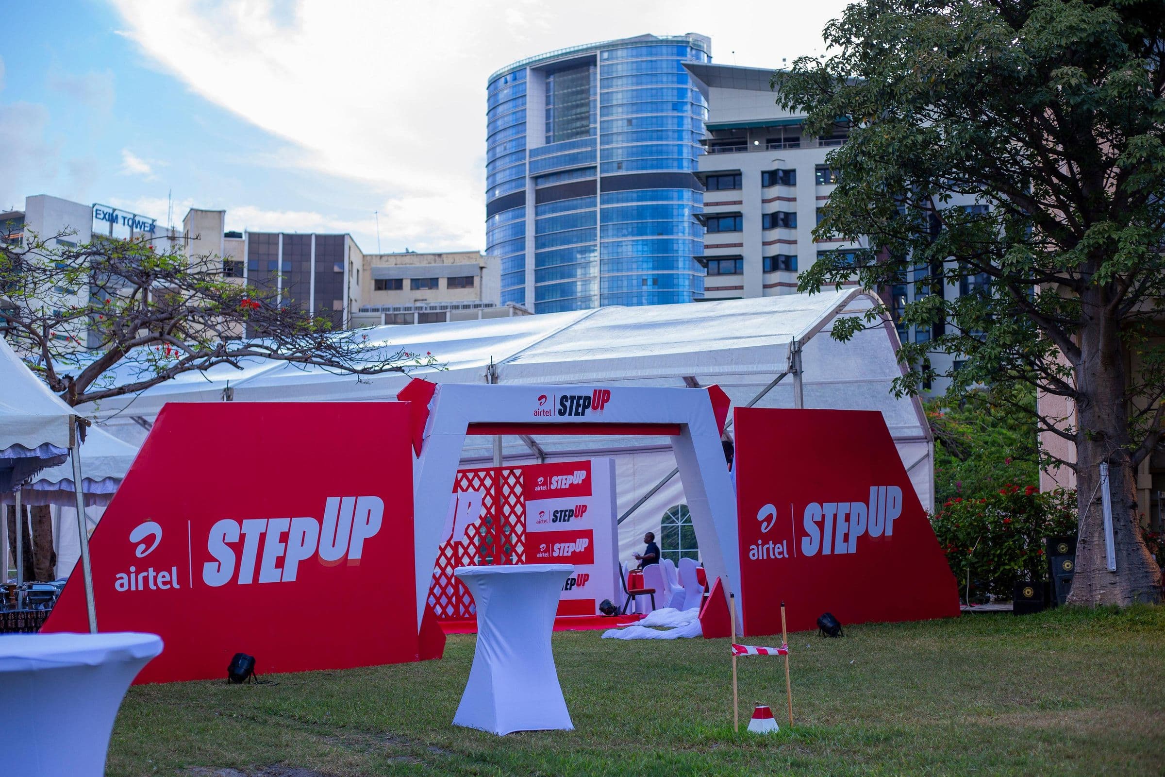Red and white tented Airtel StepUp entrance arch outside an office tower in Dar es Salaam
