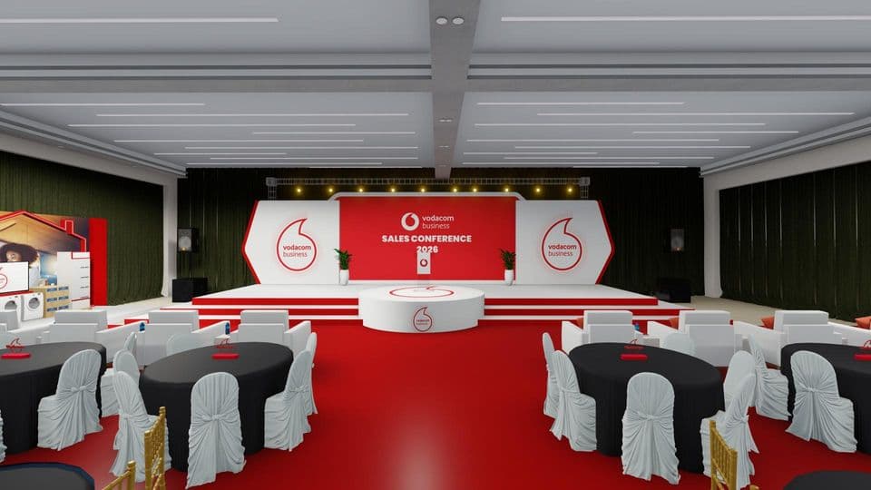 Visualization of the Vodacom Business Sales Conference hall: red and white stage with circular podium facing banquet tables